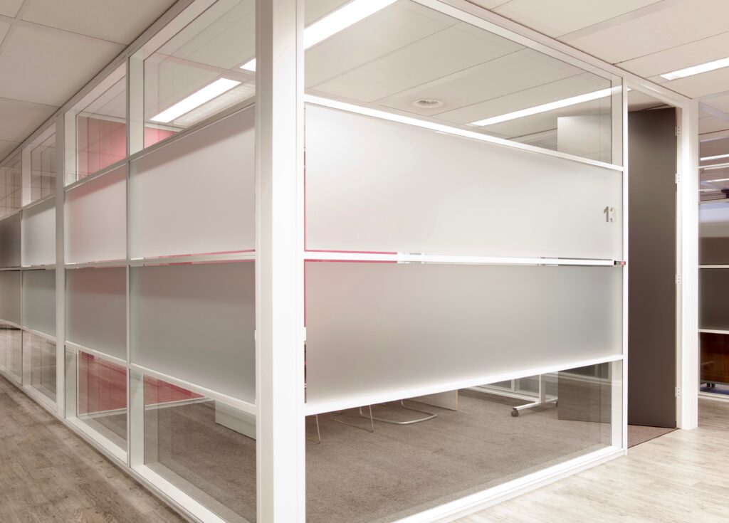 Glazen wanden scheiden een moderne vergaderruimte op kantoor.