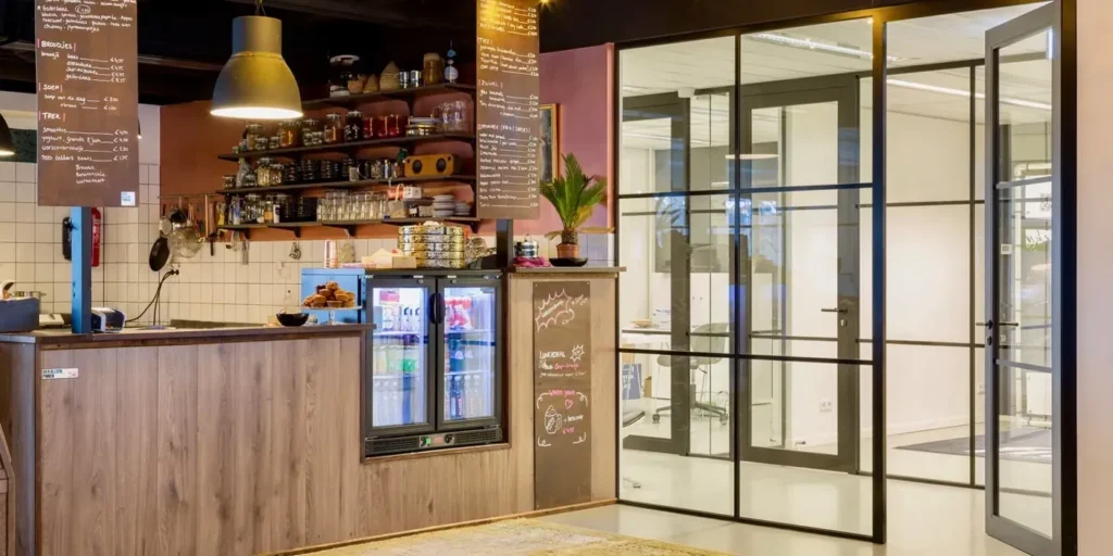 Interieur van een cafe met een doorkijk naar een kantoorruimte.